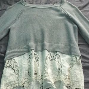 A small grey blouse with white lace sewed as one